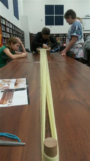 Students warping a heddle loom 